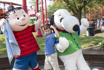 Snoopy, Linus and a fan ham it up at Cedar Fair's Kings Island near Cincinnati, Ohio.